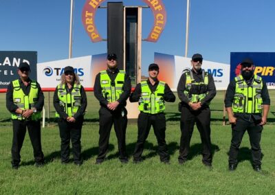 6 Security Guards in fron the "Port Hedland Turf Club" sign